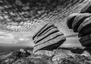 Black and white photograph of a logan stone on top of Zennor Hill in West Cornwall